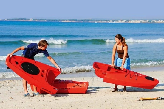 Couple carry pieces of Point 65 Martini GTX portable kayak